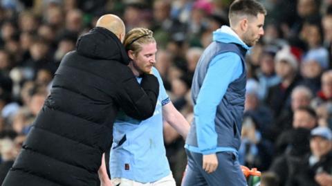 Manchester City's Kevin de Bruyne is hugged by manager Pep Guardiola after being substituted during the 3-0 win against Nottingham Forest