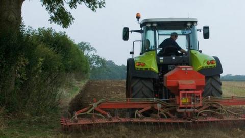 Farmer driving tractor