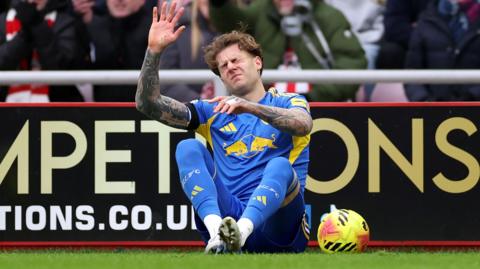 Joe Rodon of Leeds United goes down injured during the Premier League match between Sunderland and Leeds United at Stadium of Light on December 28, 2025