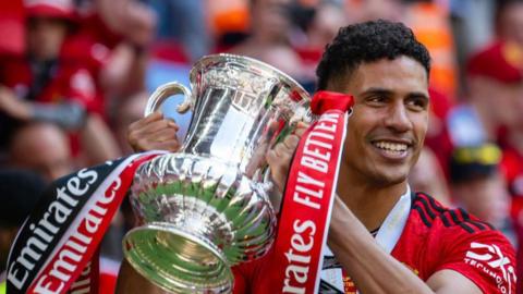 Raphael Varane hold the FA Cup aloft