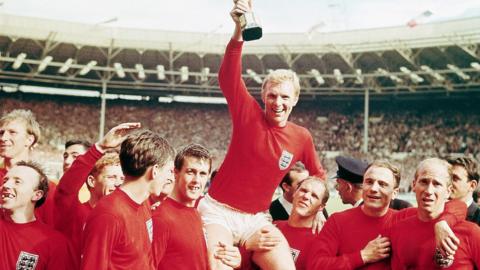 7/30/1966-England-: England captain Bobby Moore "chaired" by his team with the Jules Rimet Cup...after receiving it from the Queen after England won the Cup final 4 goals to 2, against West Germany.