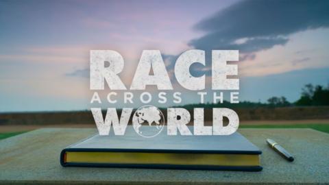 The Race Across the World sign in book closed on a table