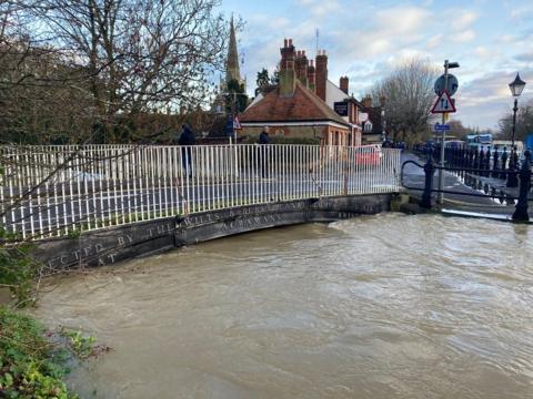 A river almost high enough to flood a bridge