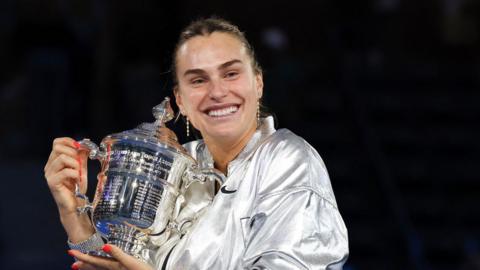 Aryna Sabalenka cradles the US Open trophy