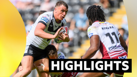 Hull FC's Harvie Hill fends off Wigan's Junior Nsemba