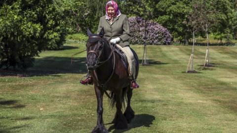 The Queen rides in the grounds of Windsor castle