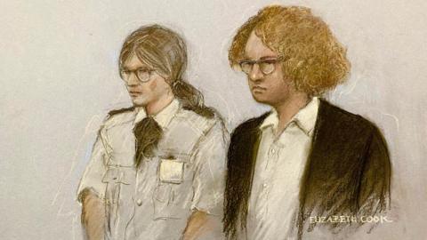 A sketch shows Gwyn Samuels standing in the dock, wearing a dark coloured jacket and a white shirt, with curly ginger hair and glasses. Next to her is a female security guard with tied-back hair and glasses.