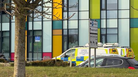 Two police vehicles parked outside King's Mill Hospital in Sutton-in-Ashfield, in Nottinghamshire. One of the vehicles is a forensic collision investigation unit van. 