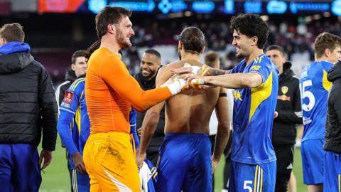 Leeds United goalkeeper Lucas Perri and winning penalty scorer Pascal Stuijk celebrate together