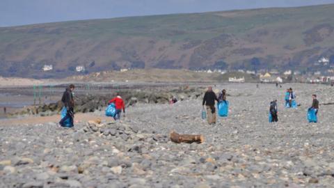 Several beach cleaners on Borth beach