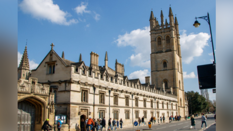 A picture of Magdalen College alongside High Street in Oxford.