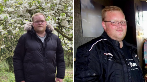  A side‑by‑side photo of a man in two different places. On the left, he is outdoors on a dirt path surrounded by green trees and a large tree covered in white blossoms, wearing a black puffer jacket with a fur‑lined hood. On the right, he is indoors near a table, wearing a black jacket with white lettering and holding a small object, with a framed picture and a bright window behind him.