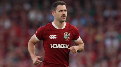 Tomos Williams running on the pitch during a match for the British and Irish Lions