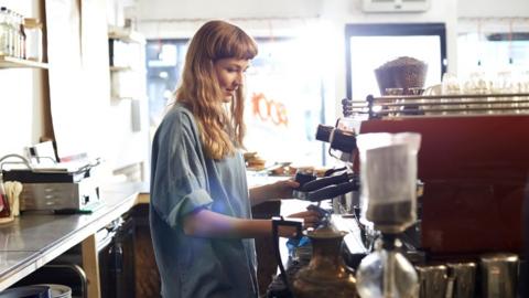 A young coffee shop barista