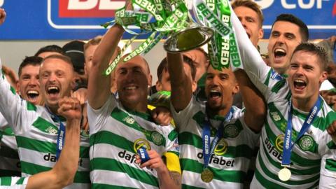 Celtic players celebrate their League Cup triumph