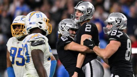 Daniel Carlson celebrates with Las Vegas Raiders team-mates AJ Cole and Foster Moreau