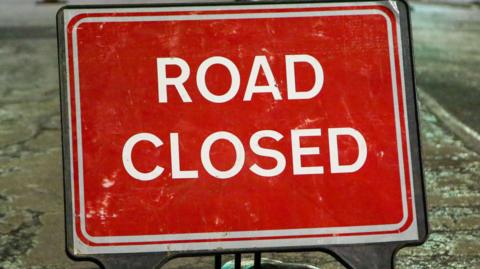 A red "road closed" sign