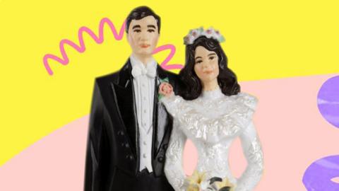 A cake topper of a bridge and groom
