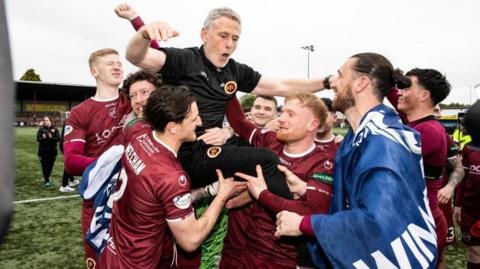 Stenhousemuir players lift manager Gary Naysmith aloft