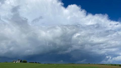 Rain clouds building above a field 