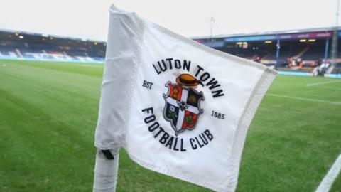 Corner flag with a Luton Town crest at Kenilworth Road