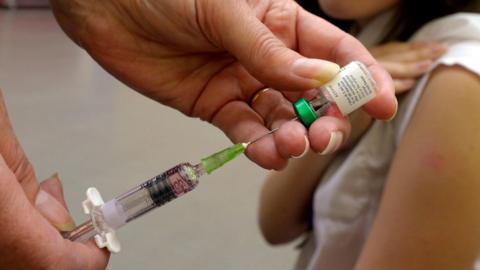 Image of teenager having a measles vaccination