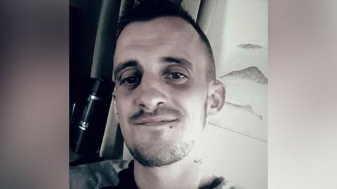 Police handout of man - Martin Forgie who died - with stubble, looking at camera.