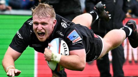 Max Norey dives over the try-line with ball in hand