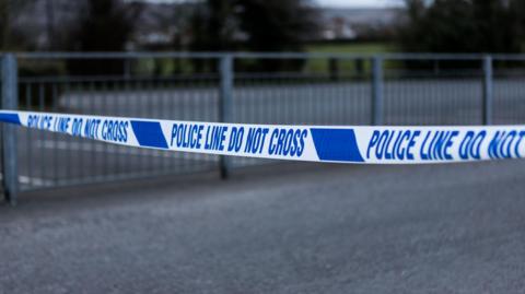 Police barrier tape in the UK - stock photo