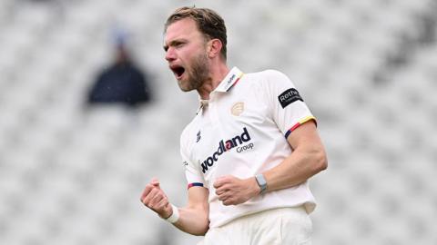 Essex's Sam Cook celebrates taking a wicket against Warwickshire