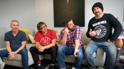 The band members of Wheatus sit on a couch
