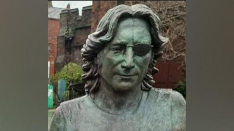 John Lennon Peace Statue showing damage