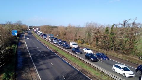 A long traffic jam of cars on the M1 motorway. 