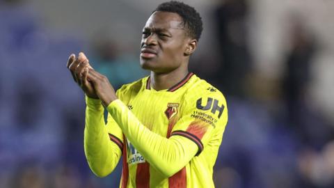 Watford's Marc Bola applauds the away fans