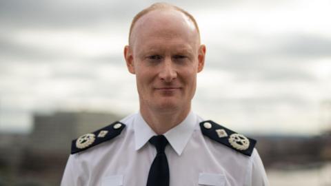 Alexis Boon wearing his uniform looking straight at the camera with a slight smile.