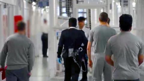 prison officers and prisoners walking around HMP Pentonville