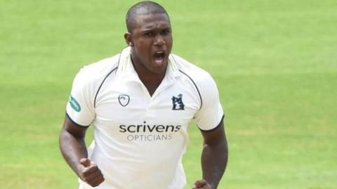 Keith Barker pumps both fists in celebration at taking a wicket