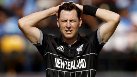 Matt Henry holds his hands behind his head in disappointment during one of New Zealand's fixtures at the 2023 Cricket World Cup