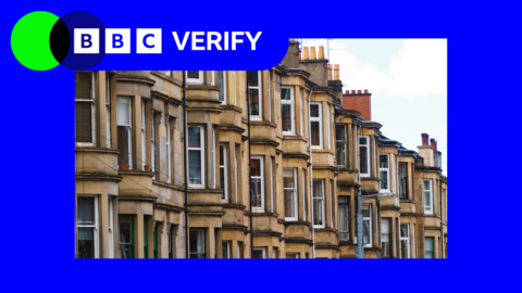 A row of tenement flats in Scotland showing the bay windows of the properties and chimney stacks. 