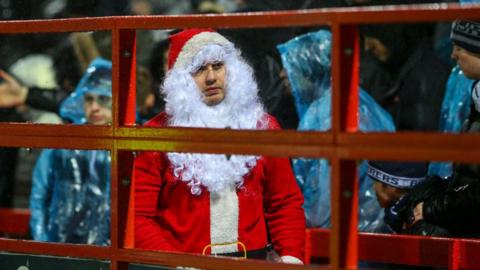 Football fan dressed as Santa.