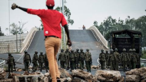 An opposition supporter challenges police during a protests following elections in Kenya in October 2017