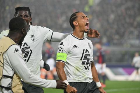 Monaco players celebrate their late winner at Bologna