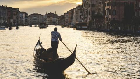 Canal Grande at sunset in Venice with gondola