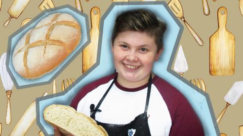 Fin holds a loaf of bread against a hand-drawn graphic wallpaper of kitchen utensils and bread. 
