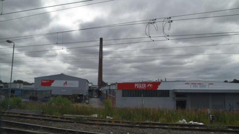 A view of the famous Pegler chimney and works just behind the train tracks