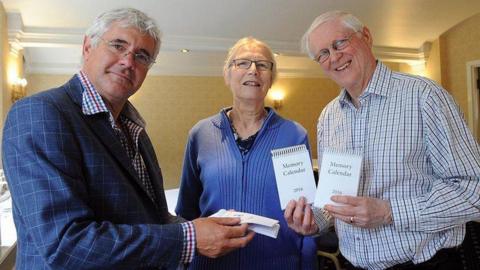 Photographer Chris Andrews with the late Keith and Val Horncastle, showing the calendar for 2016