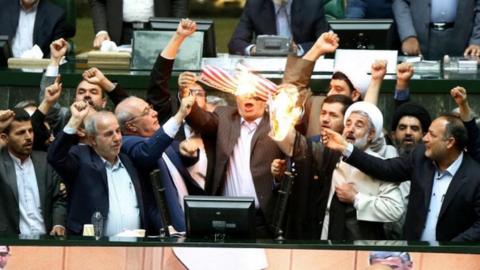 Iranian parliamentarians burn a US flag