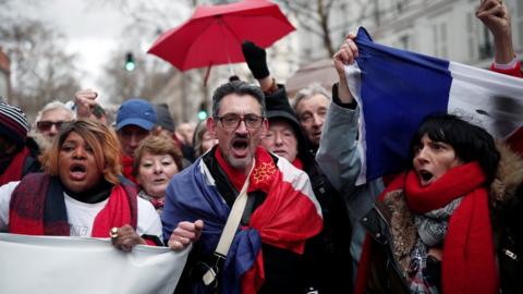 Red scarves - opponents of the yellow vests - take part in a rally in Paris,January 27, 2019