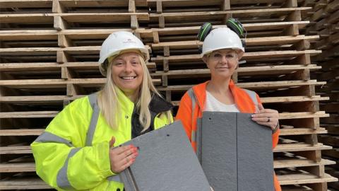 Two workers with tiles