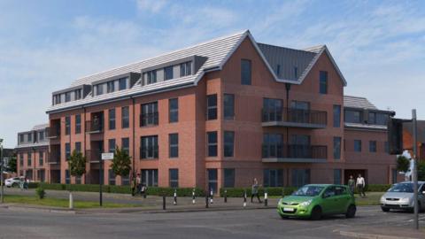 An artists mock-up of the plans for the former Langley Police station. It is a large red brick building.